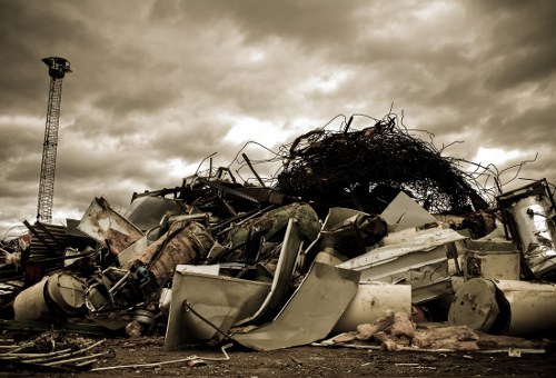 Family loading a skip for domestic waste in Mayfair
